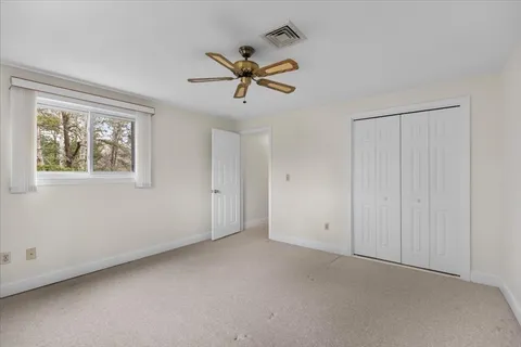 a view of empty room with ceiling fan