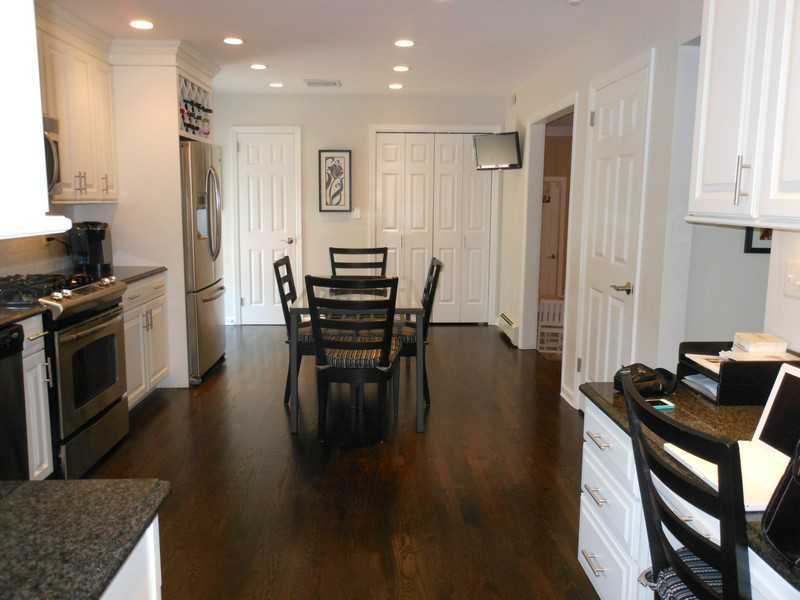 2 Griffith Road Riverside, CT 06878 - Photo 5 of 19 a kitchen with stainless steel appliances kitchen island granite countertop a stove a refrigerator a dining table and chairs with wooden floor