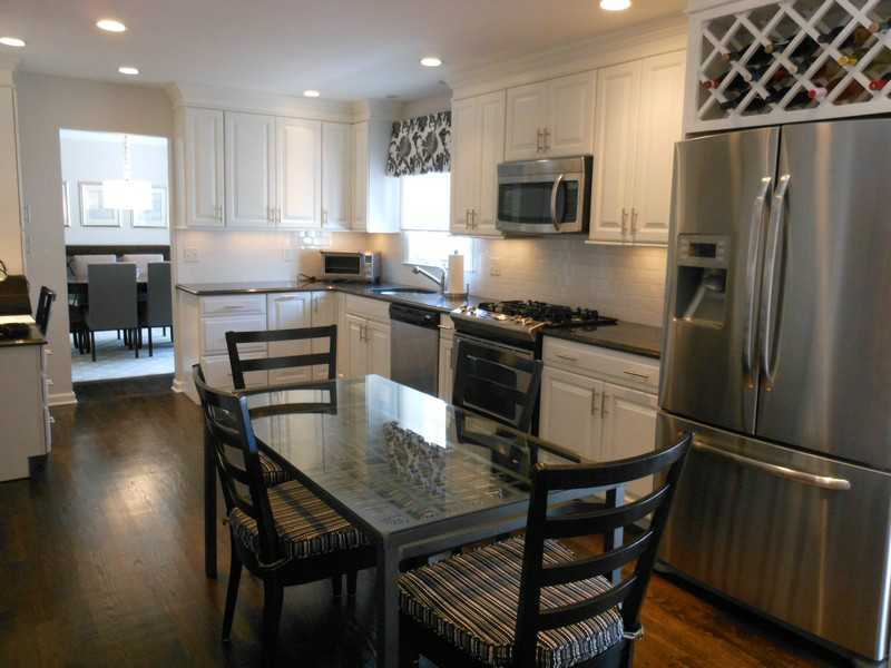 2 Griffith Road Riverside, CT 06878 - Photo 6 of 19 a kitchen with a table chairs refrigerator and microwave