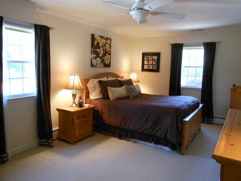 2 Griffith Road Riverside, CT 06878 - Photo 9 of 19 a bedroom with a bed and a chandelier