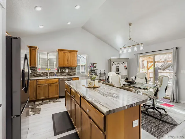 a kitchen that has a lot of cabinets a sink and appliances in it