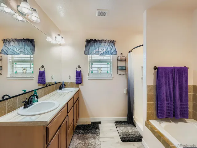 a bathroom with a sink vanity and a mirror