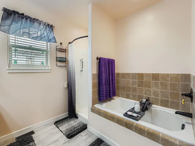 a bathroom with a tub and a sink