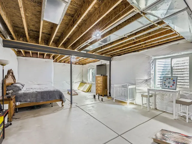 a bedroom with furniture and a large window