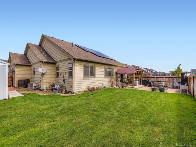 a aerial view of a house with a yard and deck