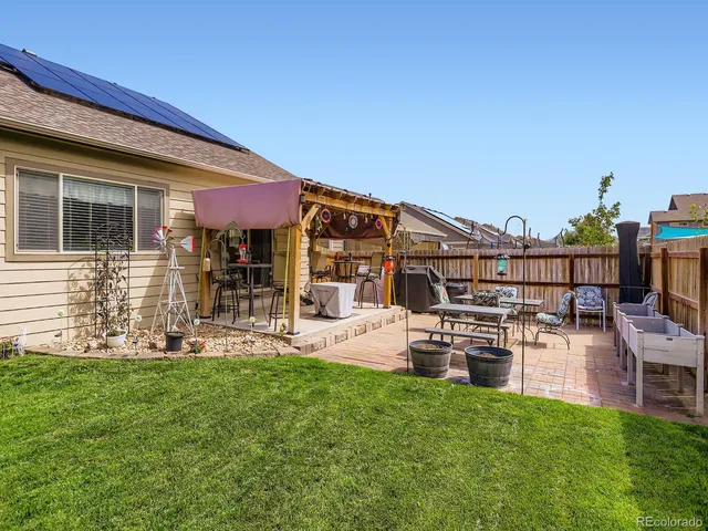 a view of a house with furniture and backyard