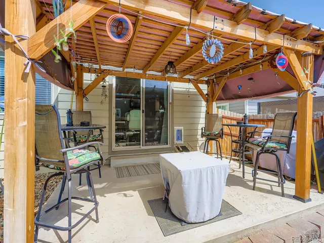 a view of the patio with dining table and chairs