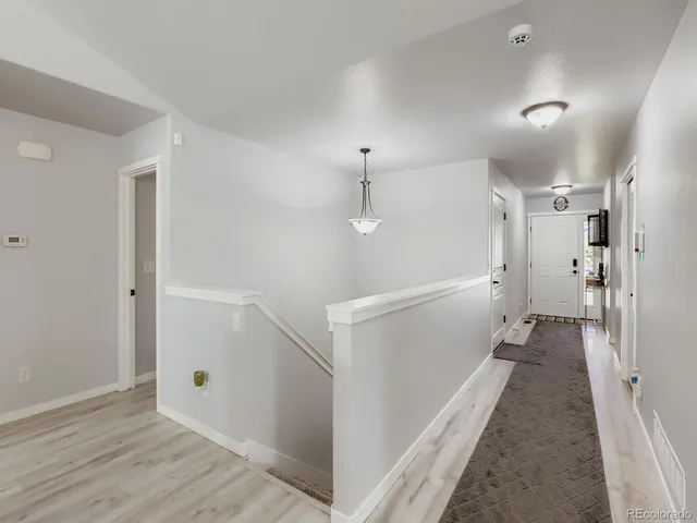 a view of a hallway with a white walls