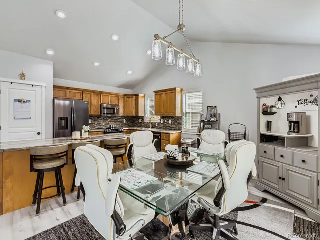 a living room with lots of furniture and kitchen view