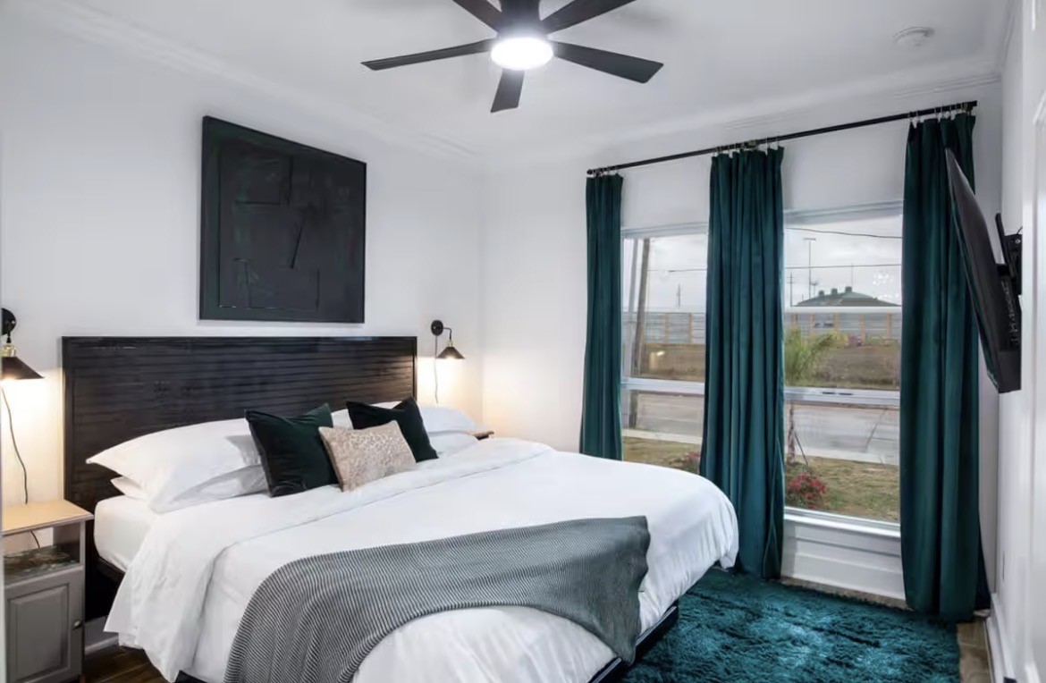 5311 Liberty Road Houston, TX 77026 - Photo 15 of 29 a bedroom with a large bed and a chandelier