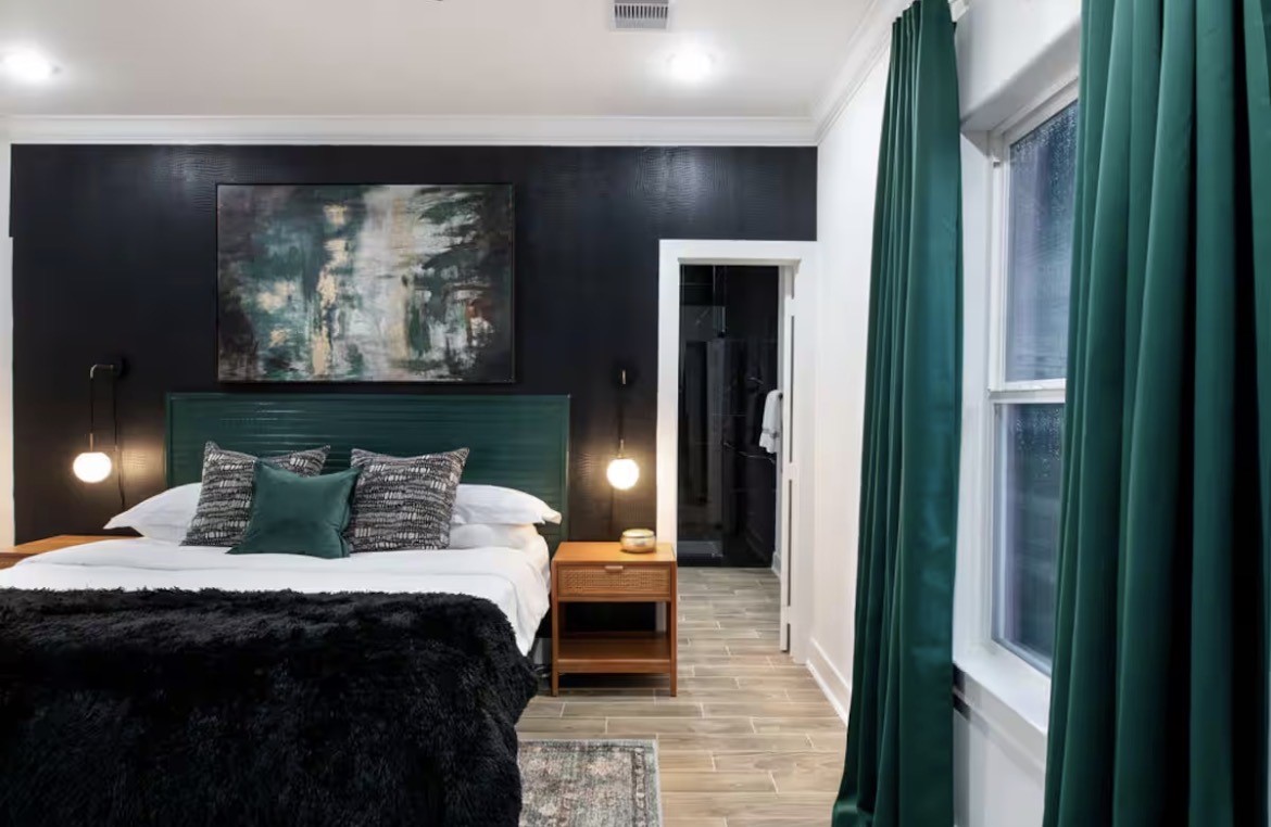 5311 Liberty Road Houston, TX 77026 - Photo 17 of 29 a bedroom with a bed and glass wall