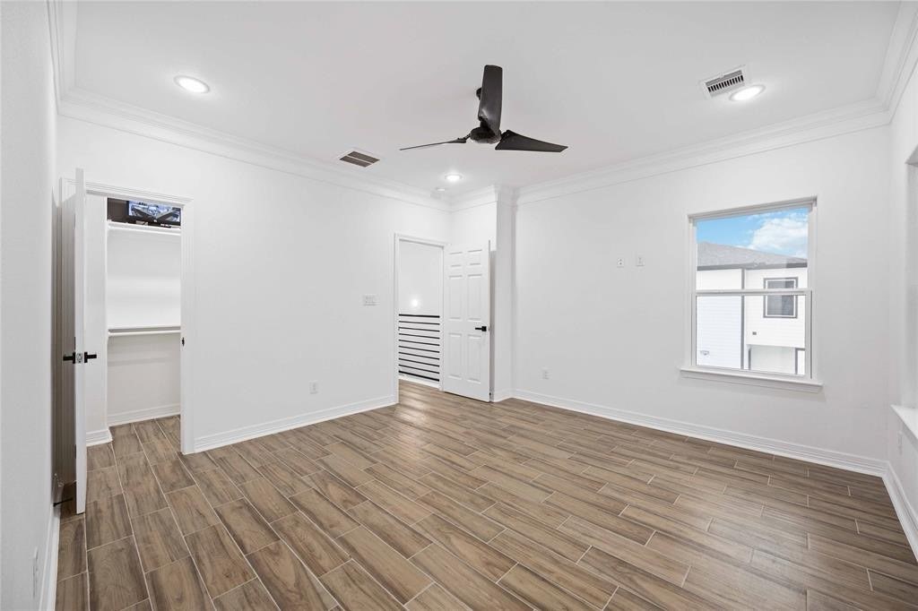 5311 Liberty Road Houston, TX 77026 - Photo 19 of 29 an empty room with wooden floor cabinet and windows