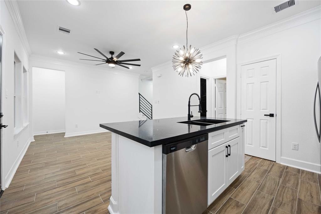 5311 Liberty Road Houston, TX 77026 - Photo 21 of 29 a kitchen with stainless steel appliances granite countertop a sink a stove and a wooden floors