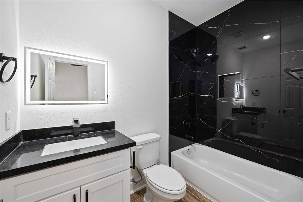5311 Liberty Road Houston, TX 77026 - Photo 23 of 29 a bathroom with a sink a toilet and shower