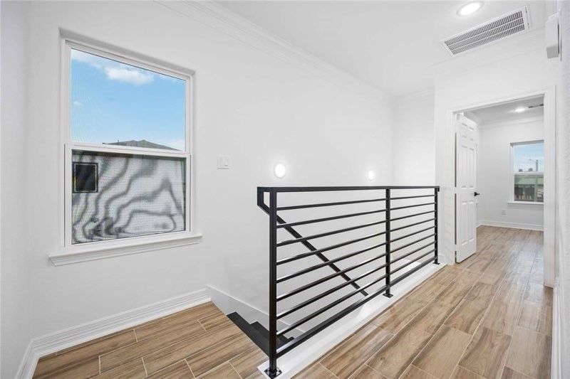5311 Liberty Road Houston, TX 77026 - Photo 25 of 29 a view of a hallway with wooden floor and staircase