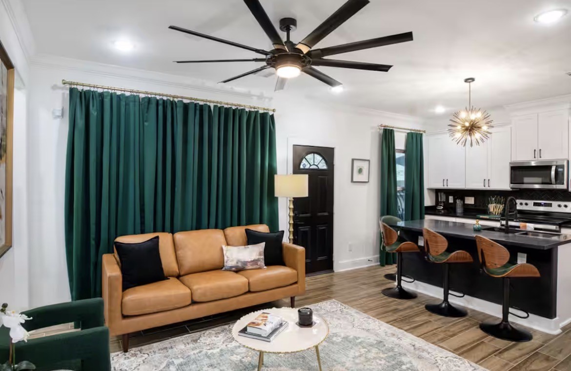5311 Liberty Road Houston, TX 77026 - Photo 5 of 29 a living room with furniture a chandelier and a bookshelf