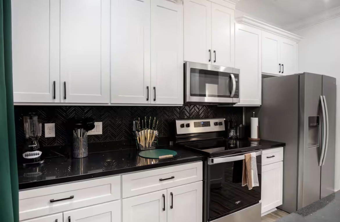 5311 Liberty Road Houston, TX 77026 - Photo 7 of 29 a kitchen with stainless steel appliances granite countertop a stove a refrigerator and cabinets
