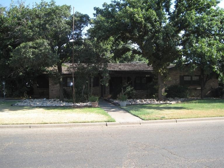 1201 16th Street Ralls, TX 79357 - Photo 1 of 10 a view of swimming pool in the backyard of house with outdoor seating and green space