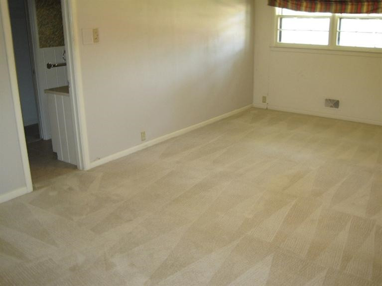 1201 16th Street Ralls, TX 79357 - Photo 9 of 10 an empty room with a window
