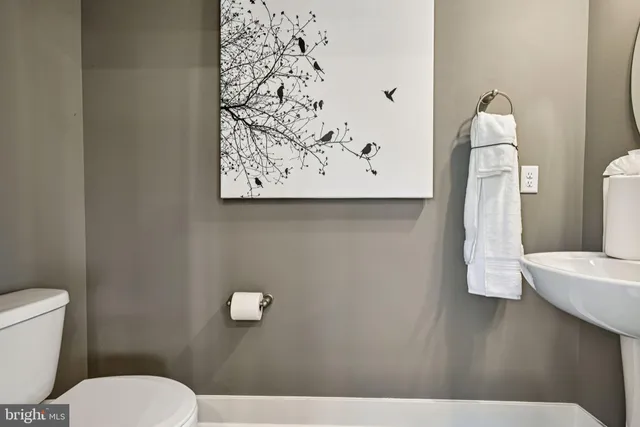 a bathroom with a toilet sink and vanity