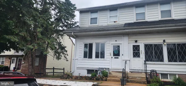 a view of house with entryway and windows