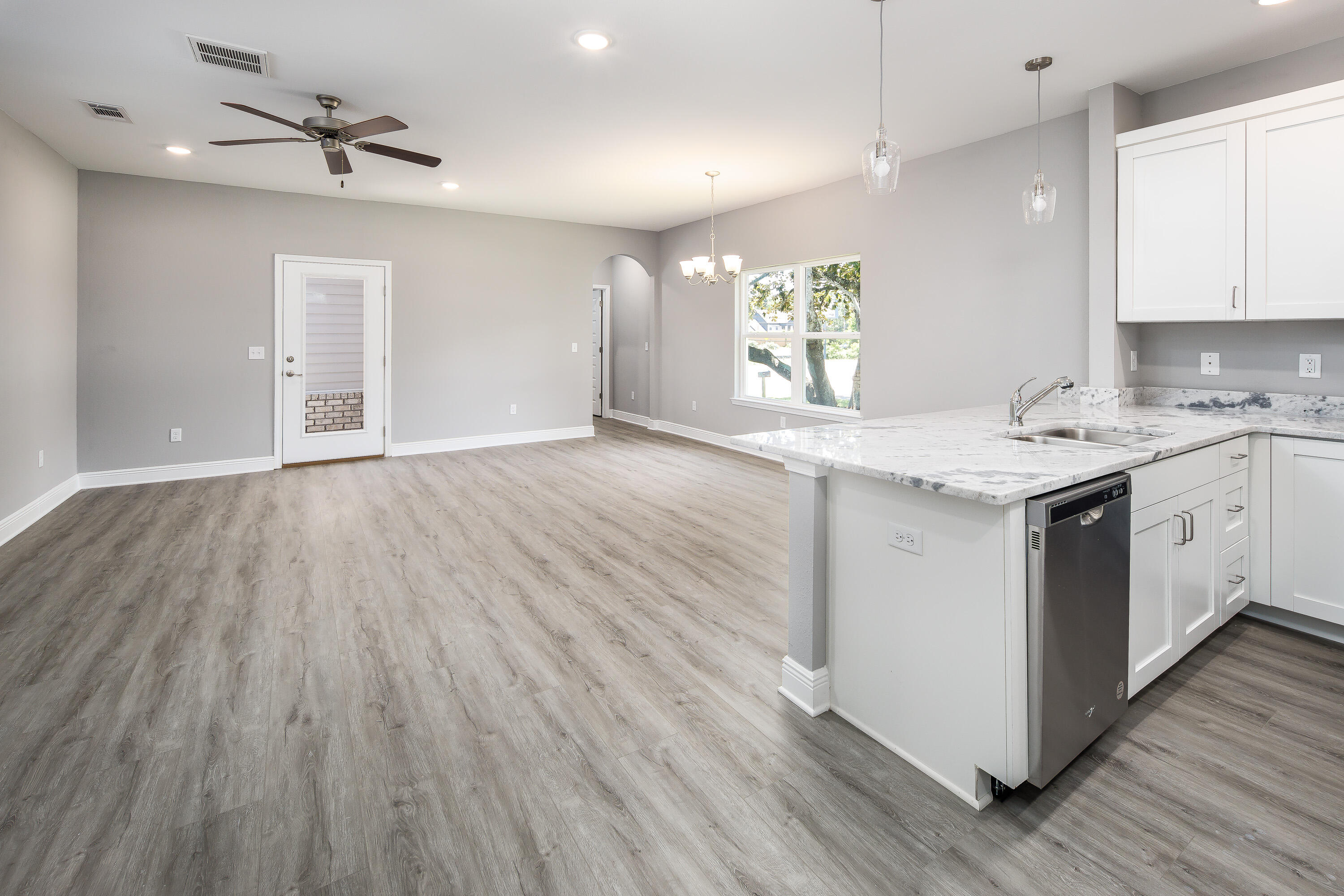 1009 Skylark Road Mary Esther, FL 32569 - Photo 11 of 42 a kitchen with a wooden floors and white cabinets