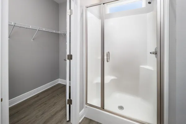 a bathroom with a glass shower door