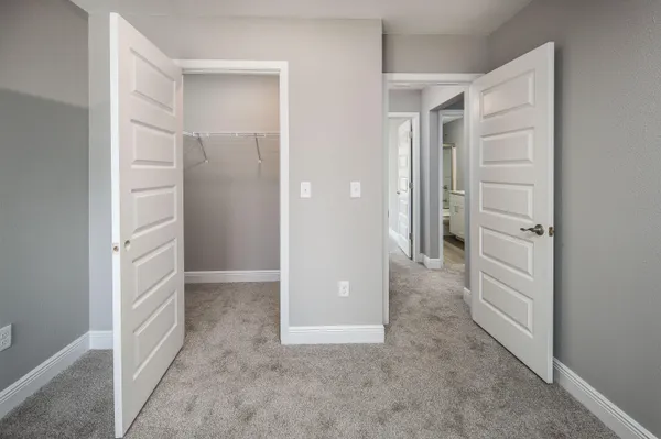 a bathroom with a granite countertop toilet sink and mirror