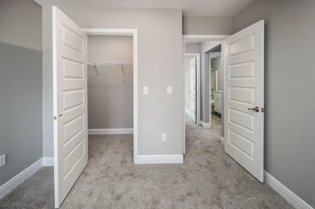 a bathroom with a granite countertop toilet sink and mirror