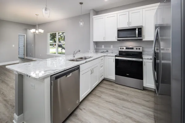 a kitchen with a sink appliances and cabinets