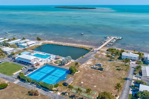 a roof deck with table and chairs