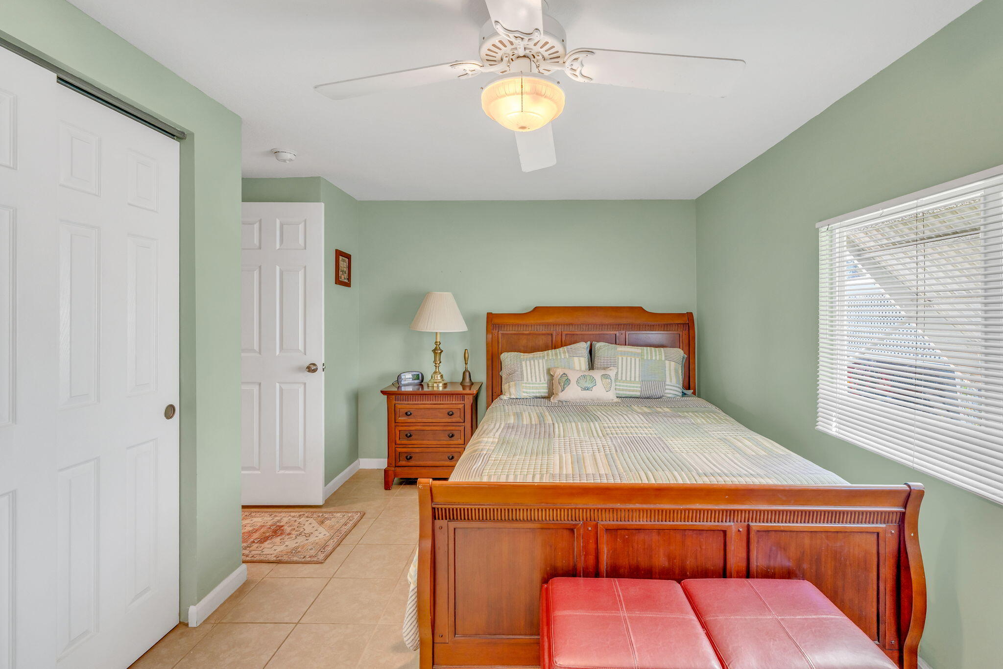 902 South Ruby Drive Key Largo, FL 33037 - Photo 22 of 44 a bedroom with a bed and a chandelier