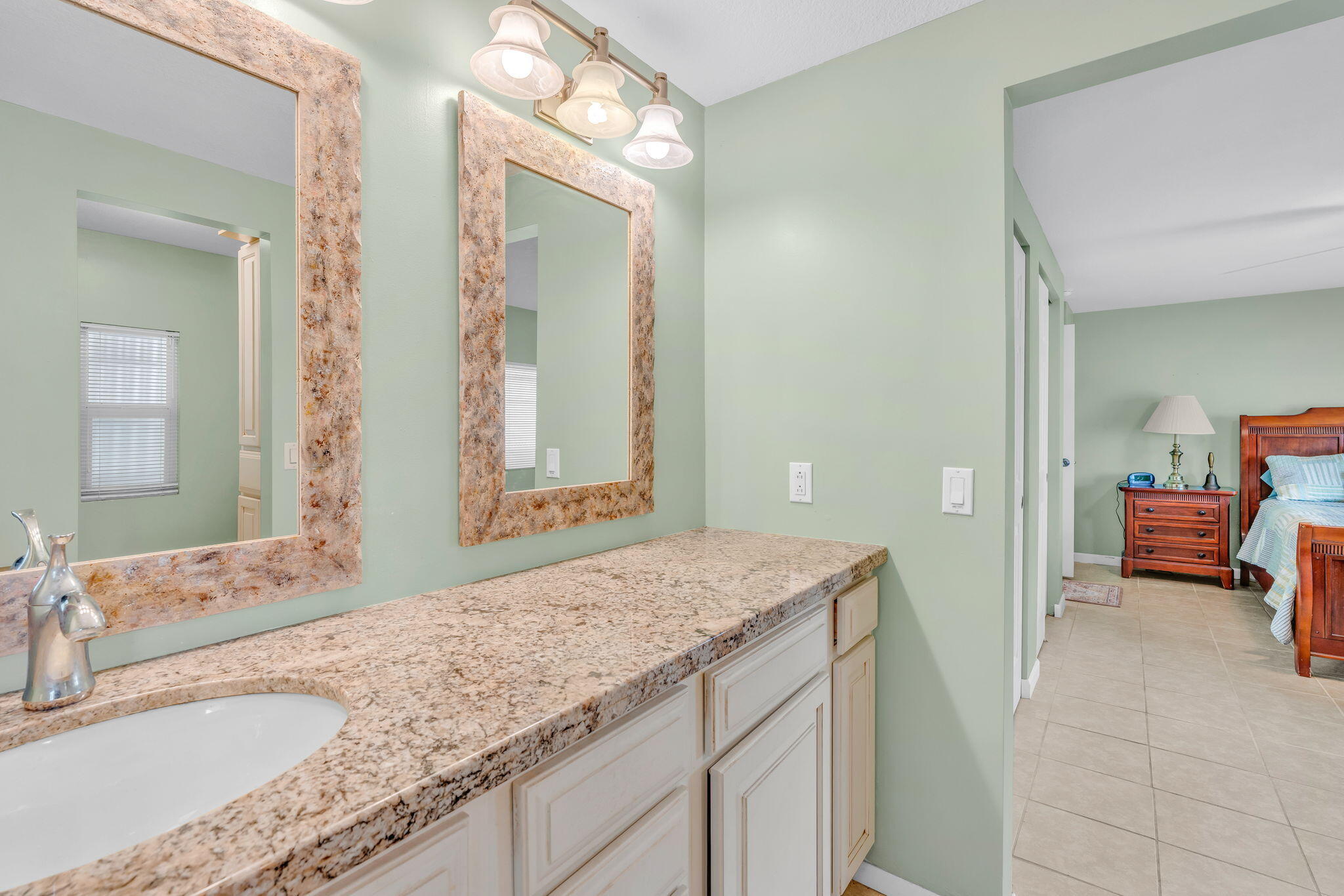 902 South Ruby Drive Key Largo, FL 33037 - Photo 26 of 44 a en suite bathroom with a granite countertop sink and a mirror