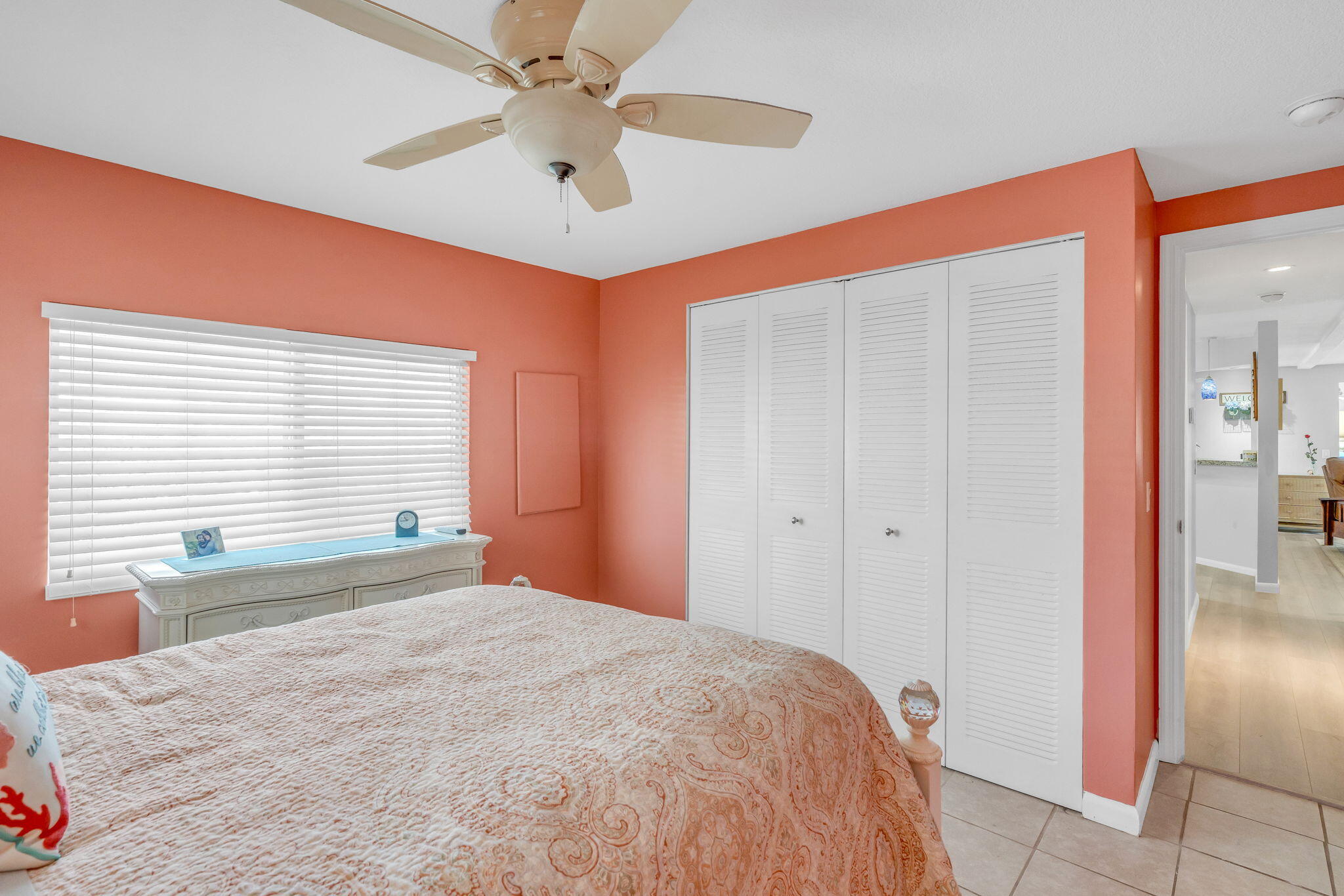 902 South Ruby Drive Key Largo, FL 33037 - Photo 30 of 44 a bedroom with a large bed and a chandelier