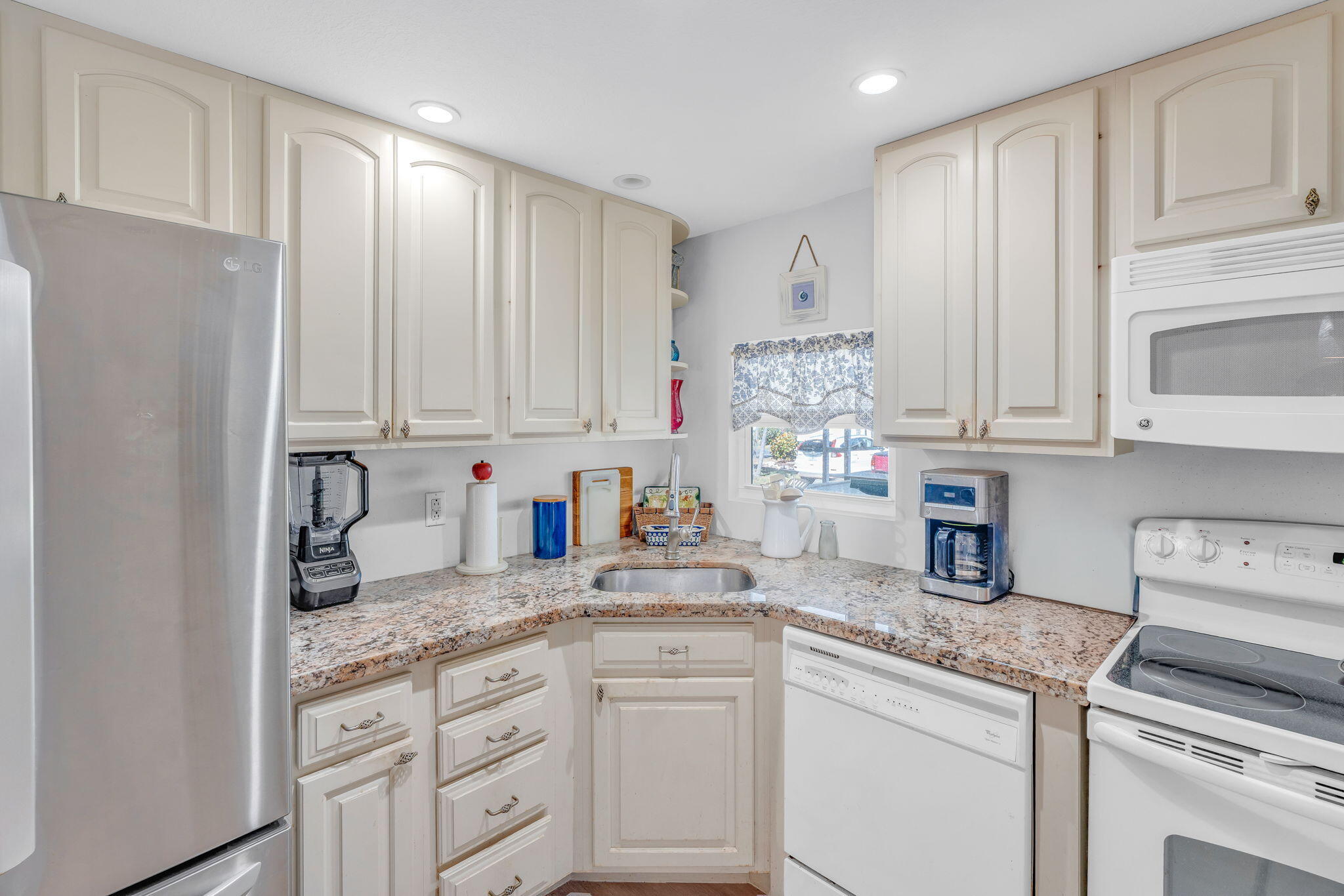902 South Ruby Drive Key Largo, FL 33037 - Photo 36 of 44 a kitchen with granite countertop white cabinets and white appliances