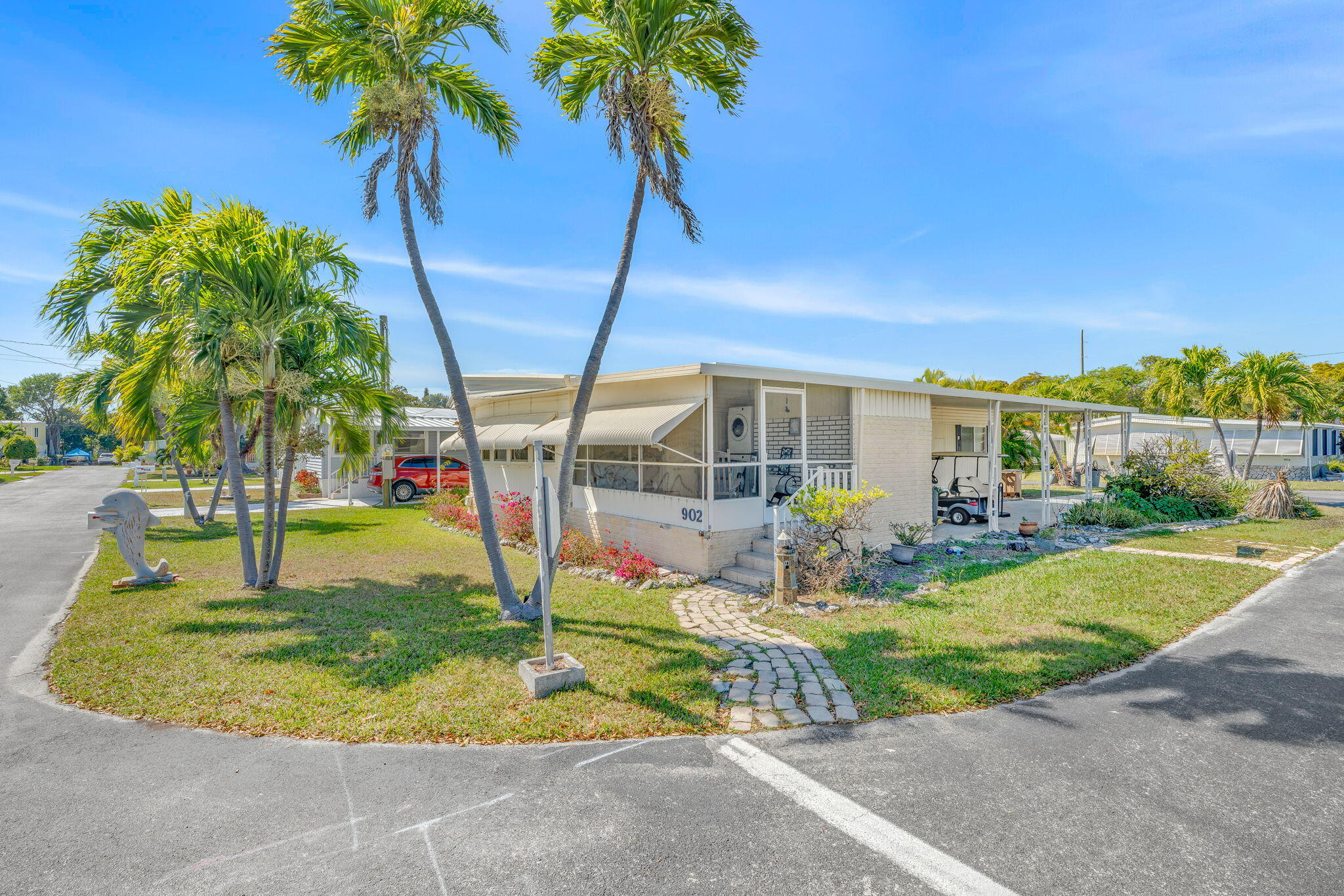 902 South Ruby Drive Key Largo, FL 33037 - Photo 4 of 44 a view of a house with swimming pool and a yard