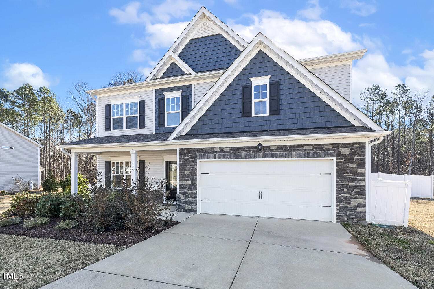 Low maintenance exterior with stone and vinyl siding.