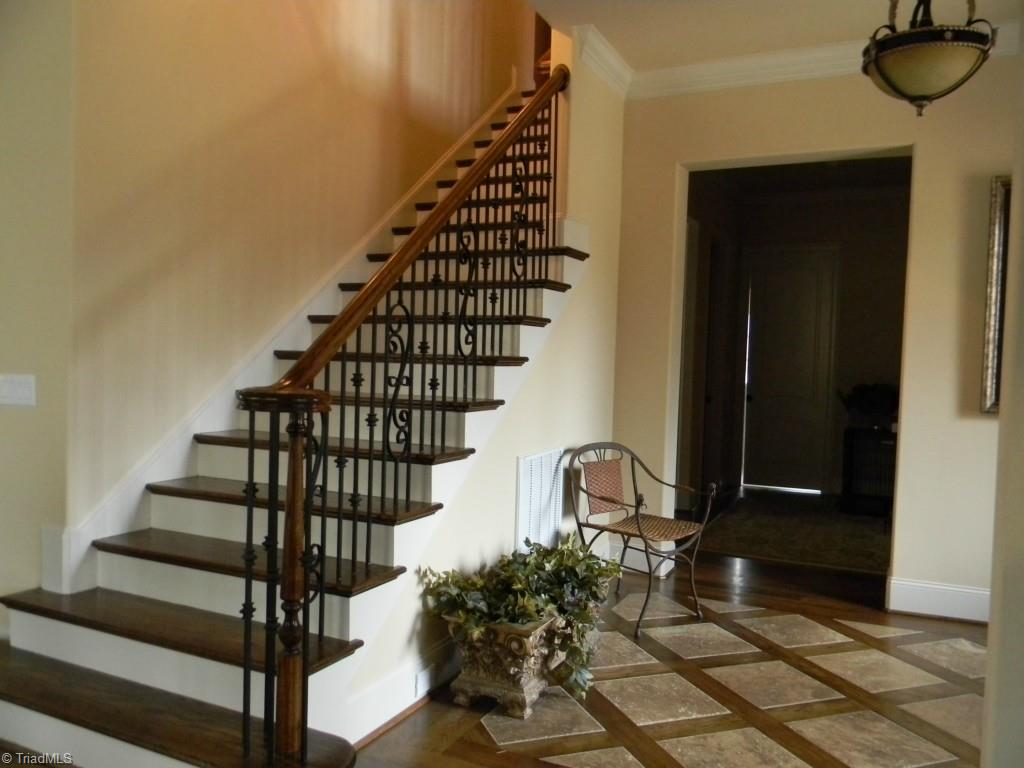 820 Pinebrook School Road Mocksville, NC 27028 - Photo 17 of 28 Hardwood floor with travertine inlay in the entry of the home.