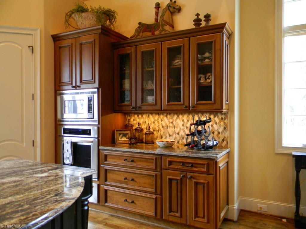 820 Pinebrook School Road Mocksville, NC 27028 - Photo 18 of 28 Granite counter tops and tile back splash really make the kitchen a showplace. There is under cabinet lighting as well as rope lighting above the cabinets.