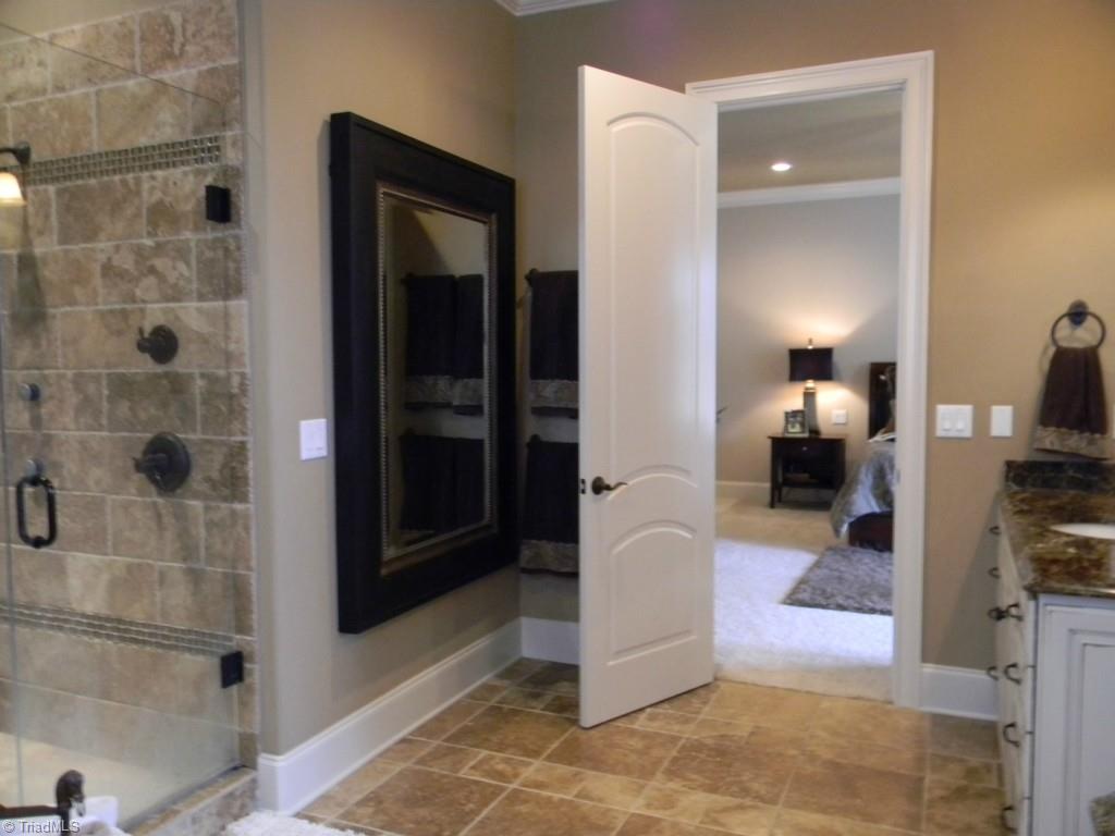 820 Pinebrook School Road Mocksville, NC 27028 - Photo 22 of 28 Master bath with dual vanities, Travertine flooring and shower.