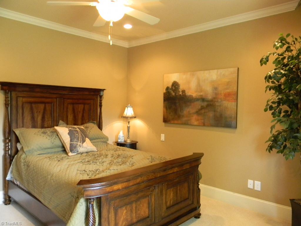 820 Pinebrook School Road Mocksville, NC 27028 - Photo 24 of 28 Generous guest bedroom on upper level with large walk in closet that also accesses the walk in storage area of the attic.