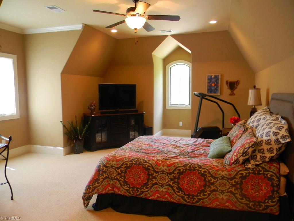 820 Pinebrook School Road Mocksville, NC 27028 - Photo 25 of 28 The larger guest bedroom upstairs has plenty of room for the bed and a sitting area. It has private access to the Jack and Jill bath and has a large walk-in closet.