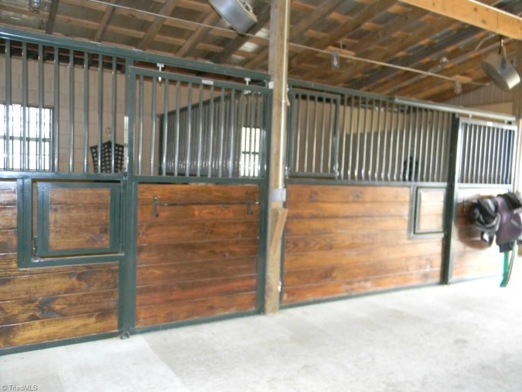 820 Pinebrook School Road Mocksville, NC 27028 - Photo 9 of 28 Interior of new wing of barn with 3 Classic Equine Stalls.