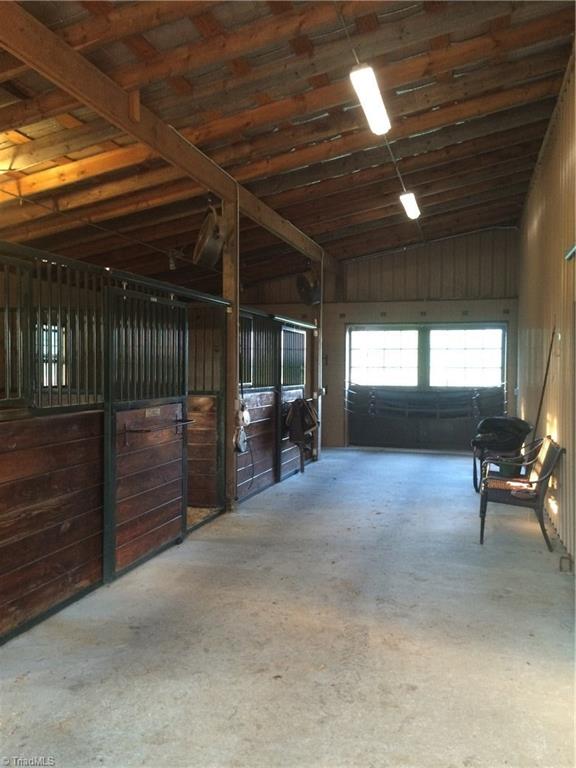 820 Pinebrook School Road Mocksville, NC 27028 - Photo 10 of 28 The newer wing of the barn consists of three 12' X13' Classic Equine stalls with sliding doors and swing out feed and water doors. It has a concrete aisle and also includes a storage area for hay, pitch forks and the fly spray system.