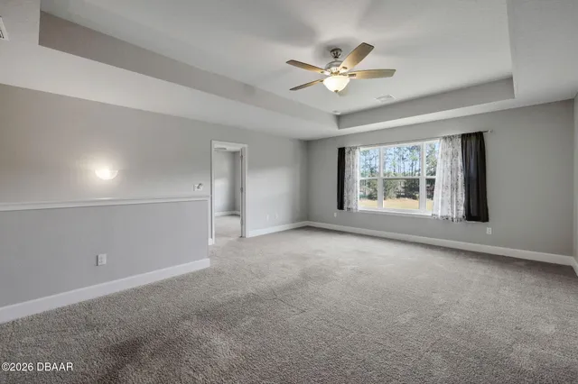 a view of a livingroom with a ceiling fan and window