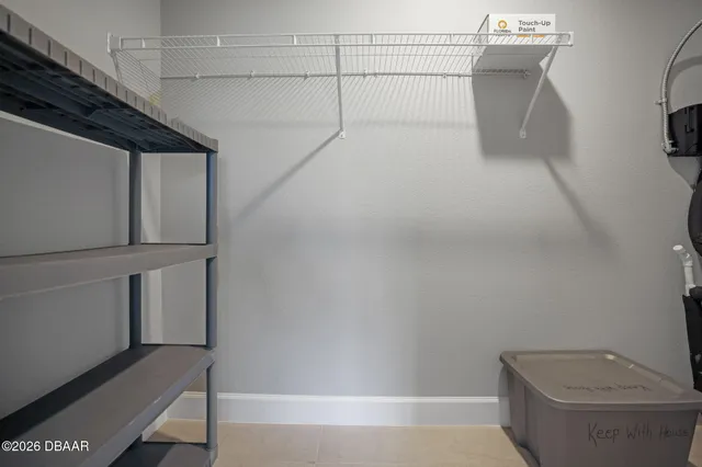 a view of storage and utility room with racks on the wall