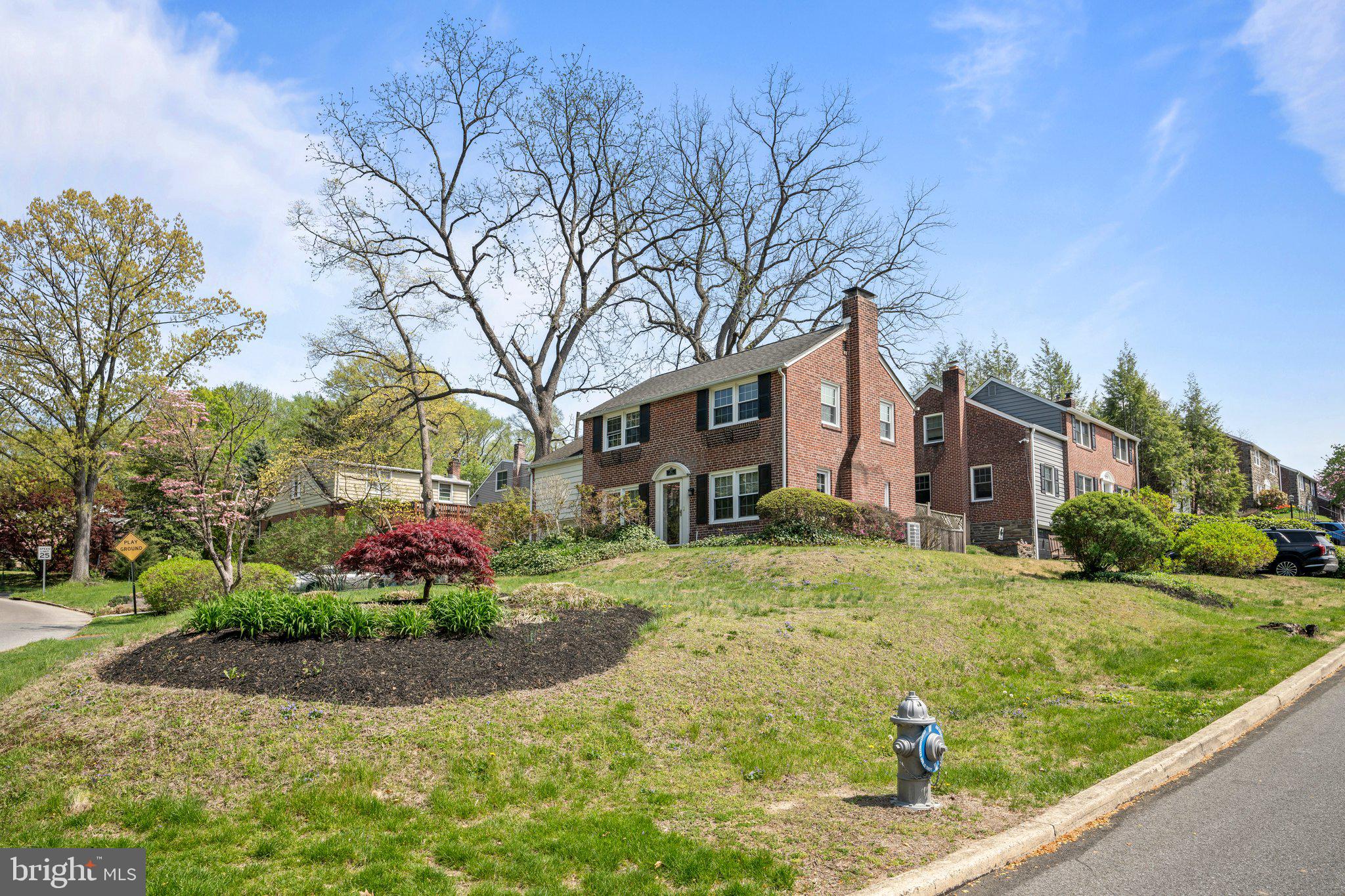 827 Dover Road Wynnewood, PA 19096 - Photo 3 of 23 a front view of a house with a garden and trees