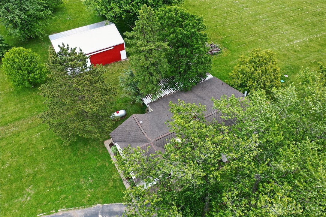 2470 Clark Run Road Xenia, OH 45385 - Photo 18 of 57 Aerial view of a home surrounded by lush greenery, featuring an outbuilding on a spacious lot.