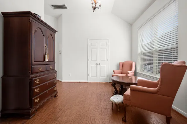 a living room with furniture cabinets and a window