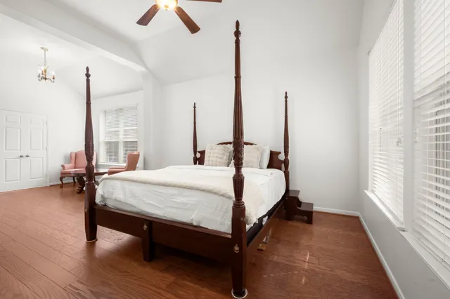 a large bed sitting in a room next to a window